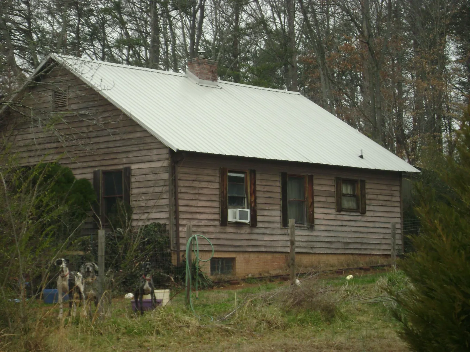 White metal roof on an old wood sided farmhouse, from a Metal Roof Installation job in Red Rock